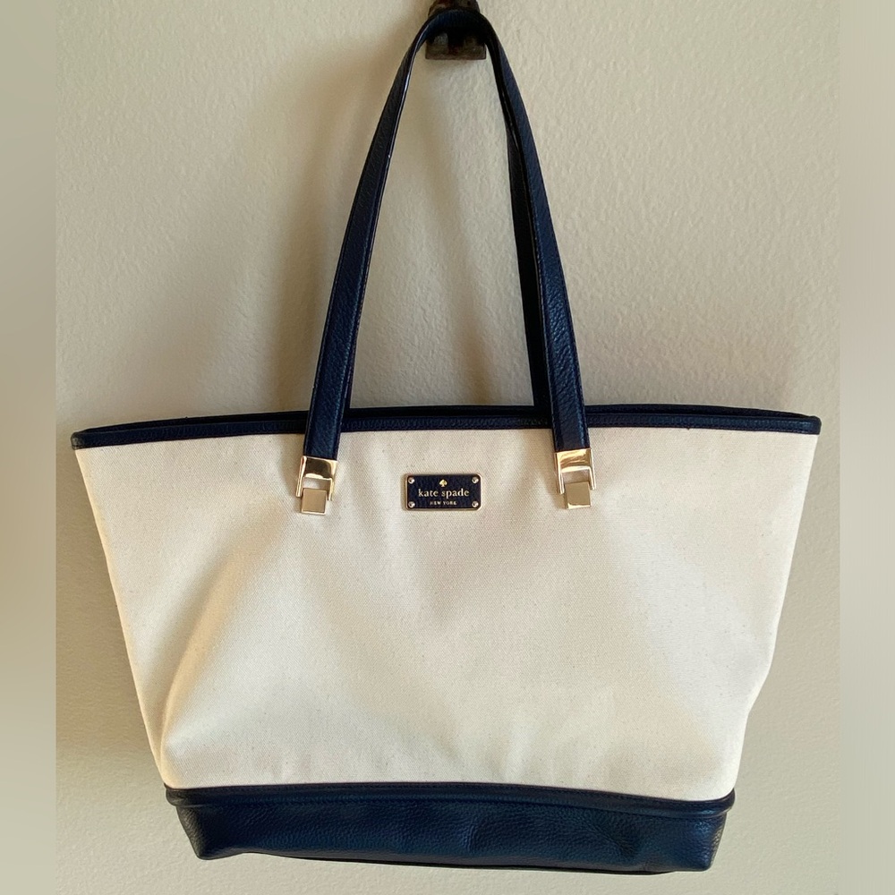 Kate Spade cream canvas tote with navy leather straps and trim. NWOT.